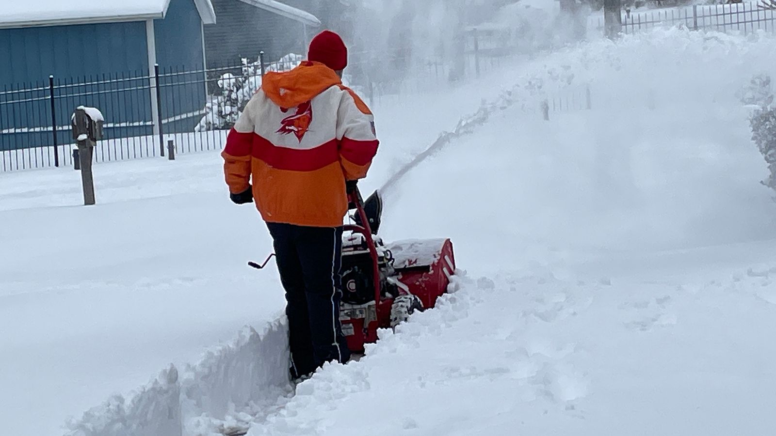 Photo of a person removing snow with a snowblower in St. Charles, MO.